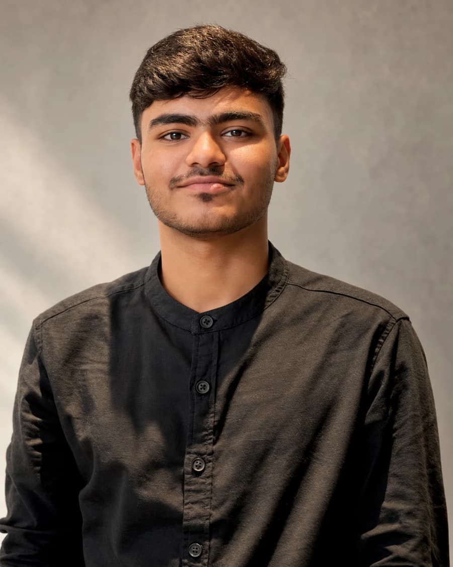 Mohammad Awais in a charcoal shirt, photographed in soft natural light